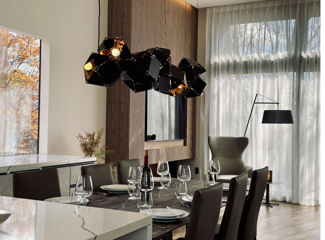 Dining table beneath a sculptural chandelier